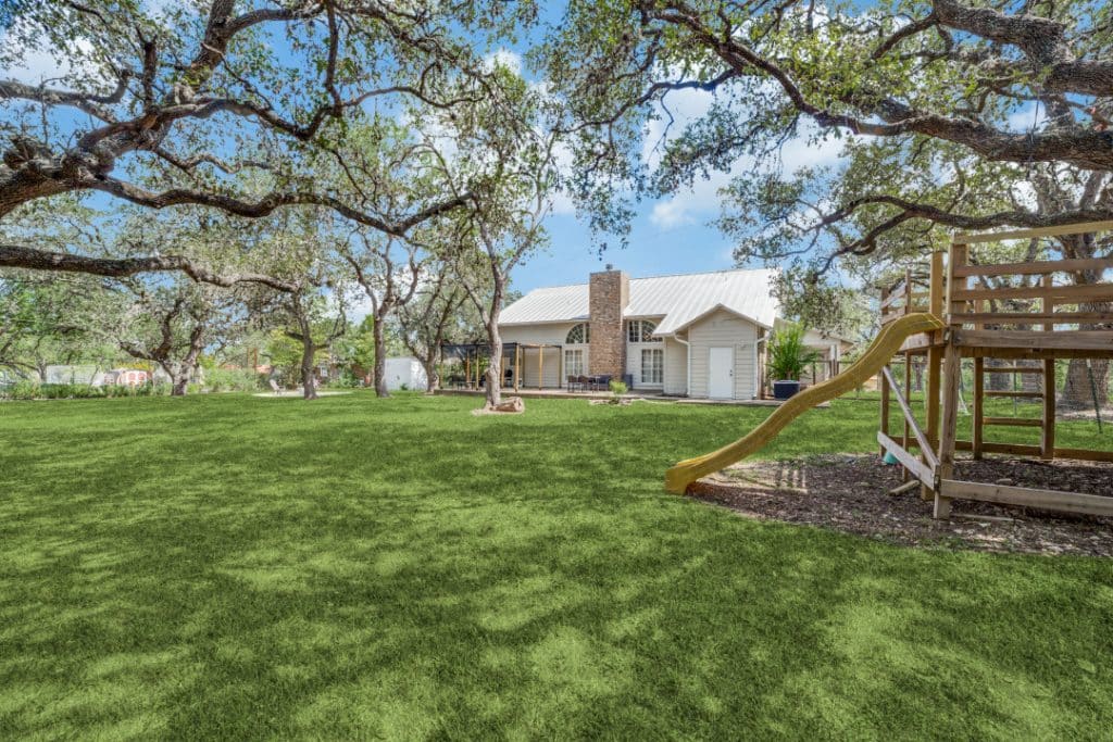 Backyard with treehouse, zip line, and back patio at a family-friendly vacation rental near SeaWorld and Six Flags.
