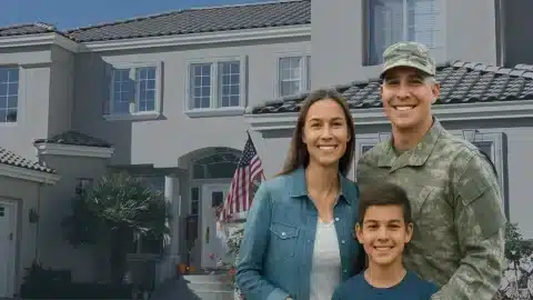 Smiling military family in front of a suburban San Antonio home with an American flag